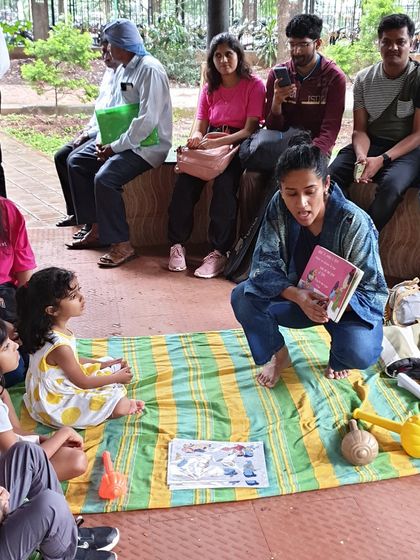A storytelling session at the Cubbon Park bandstand on a rainy day. This shows our commitment to keeping the stories going, adapting to the weather to provide a cozy and memorable experience.