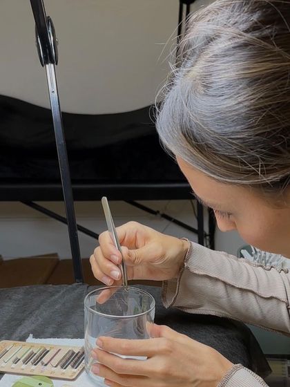 Preparation is key. Here, an instructor carefully prepares the lashes for a procedure, a critical step for achieving perfect results that we cover in detail during training.