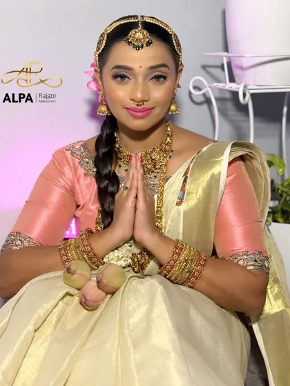 A traditional 'namaste' pose, capturing the grace and elegance of the South Indian bridal look.