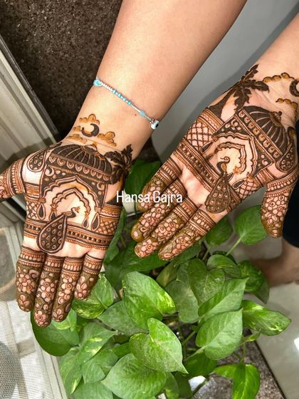 A graceful Karwachauth design with peacock and palace motifs. The patterns are elegant and tell a story of romance and tradition.