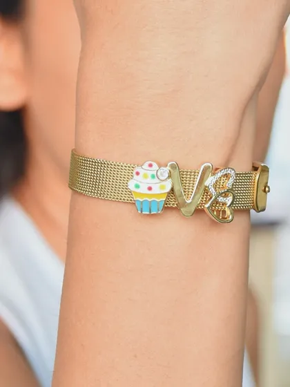 A cute and simple custom watchbelt bracelet, featuring a cupcake charm and the initial 'V'.