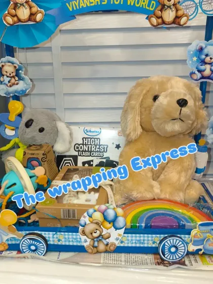 'Viyansh's Toy World' cart, filled with soft toys and educational flash cards for the new baby.