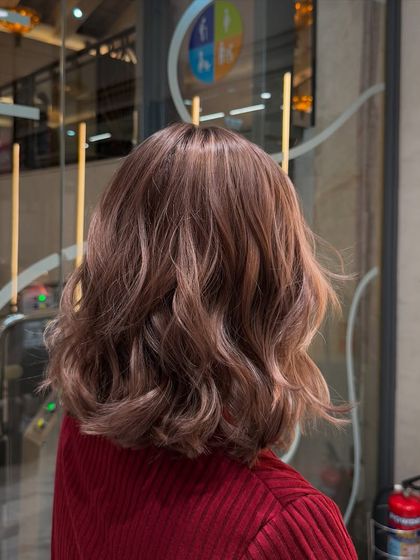 A beautiful, soft, rosy-brown color on a wavy bob. This look was created with a custom Redken formula for a dimensional, natural look with cool and neutral tones.