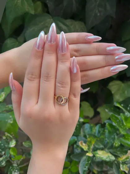 A stunning example of the popular chrome nail trend. I used a high-quality chrome powder over long stiletto extensions to create this liquid-metal, pearlescent effect that shifts beautifully in the light. This look is modern, chic, and incredibly eye-catching.