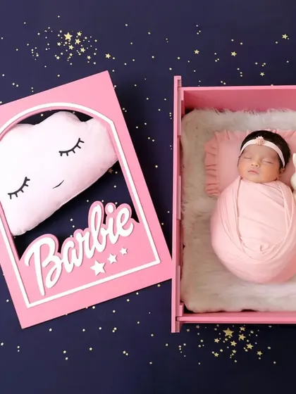 A wider view of the Barbie-themed shoot, showing the dreamy, starry backdrop and the adorable cloud pillow that complete this picture-perfect scene.