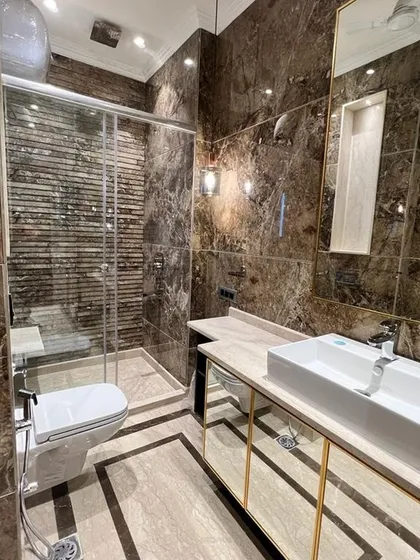 I believe your bathroom should feel like a private spa. This space is wrapped in rich, dark Italian marble, with a spacious walk-in shower and carefully chosen fixtures. It’s your personal retreat to unwind after a long day.