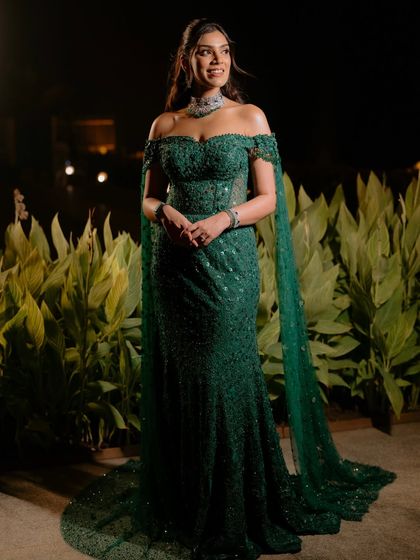 A full-length shot showing the complete reception look. The soft glam makeup perfectly balances the drama of the sequined Tarun Tahiliani gown and its flowing cape.