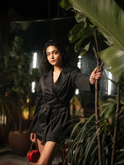 An atmospheric on-location night shoot for Freyja. I used the ambient lighting and lush green background to create a moody and sophisticated scene, highlighting the model's trench coat and the brand's chic aesthetic.