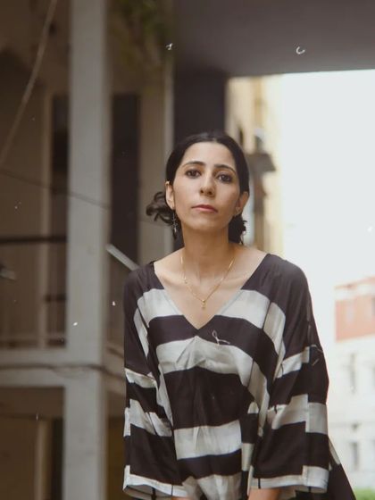 A street style portrait for House of Wandering Silk. The urban background provides a modern context for the timeless, striped dress.