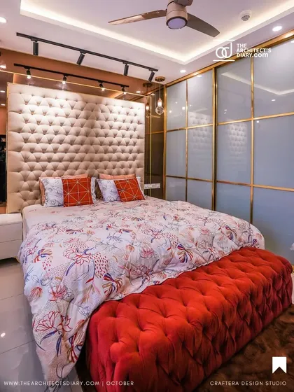 This master bedroom is a perfect example of blending luxury with comfort. I designed this grand, fully-upholstered tufted headboard as a centerpiece, complemented by sleek, lacquered glass sliding wardrobes for a touch of modern elegance.