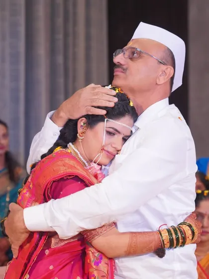 An emotional and priceless moment as the bride hugs her father during the wedding ceremony. Capturing these heartfelt family interactions is a core part of our candid wedding photography.
