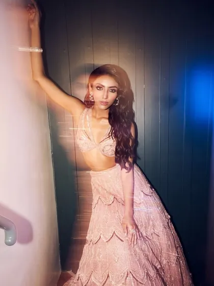 My blush pink signature embellished lehenga, a masterpiece of intricate embroidery, shimmering beads, and delicate geometric patterns.