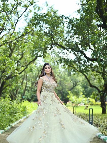 A walking shot of the pastel green gown, capturing the movement and grandeur of the full skirt.