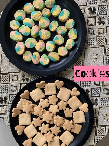 A playful assortment of homemade cookies, including colorful rainbow cookies and cute heart and star-shaped butter cookies. Made with love for the festive season.