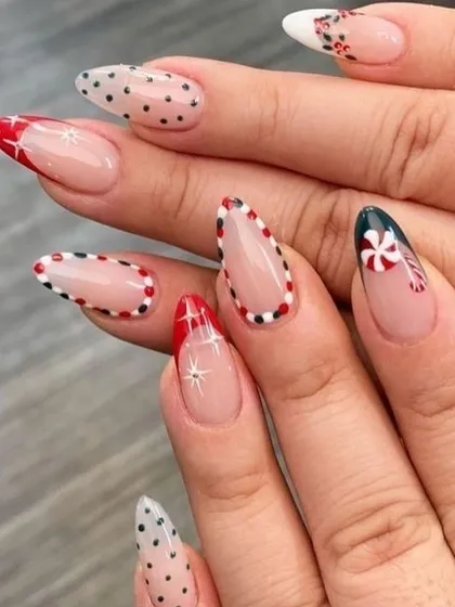 A chic and modern Christmas design on long, almond-shaped nails. This set features peppermint candy art, delicate polka dots, and sparkling star details, using a negative space technique for a trendy finish.