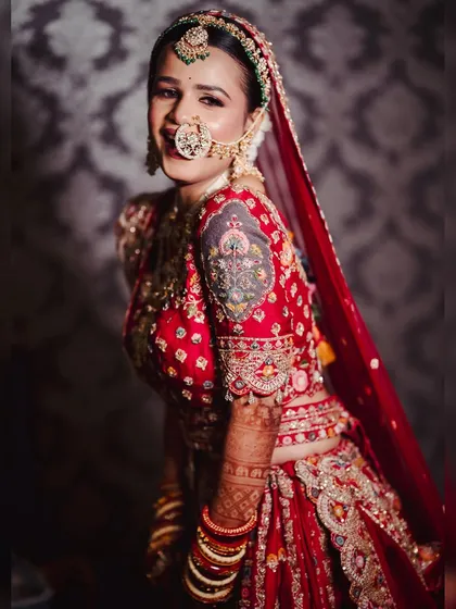 A playful and happy bride. Her complete look, from the makeup to the perfectly draped dupatta, is designed to let her personality shine.