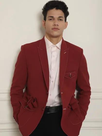 A confident stance in my red designer suit jacket. My suits are designed to match your personality, ensuring you look and feel your best.
