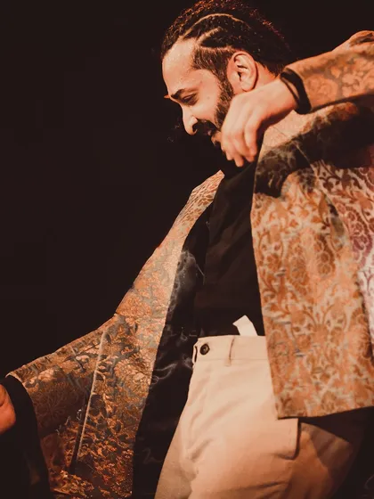 A mid-performance shot, showing the intricate details of the costume and the dynamic movement.