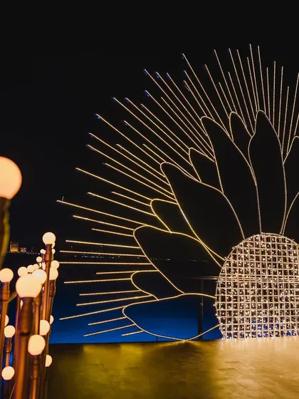 A glimpse of the intricate lighting setup for a sunflower-themed decor piece. This is part of the madness we love, the behind-the-scenes work that makes our events shine.