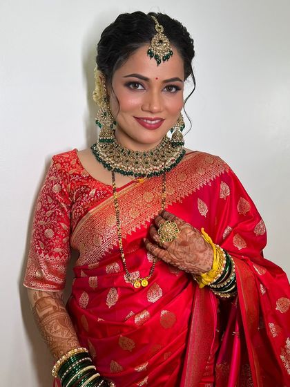 A beautiful portrait of the bride, her makeup perfectly complementing her traditional reception attire.