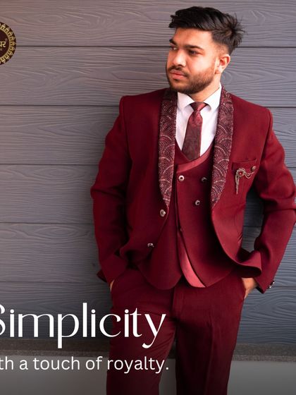 Simplicity with a touch of royalty. A full-length view of the maroon suit, demonstrating its powerful and regal presence.