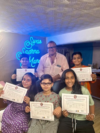 A group of our proud students with their teacher after clearing the Gandharwa Mahavidyalaya exams. We provide complete preparation for these certified music examinations.