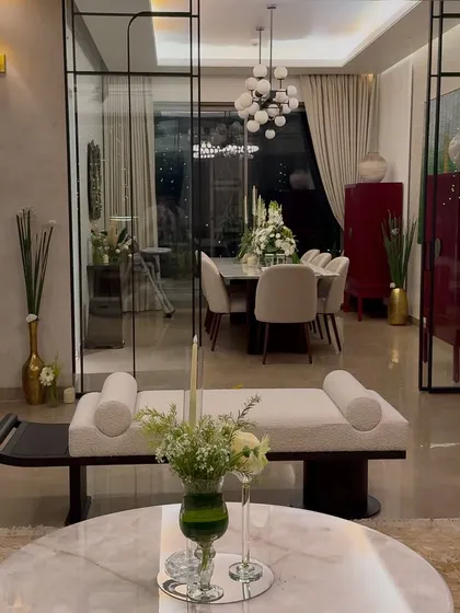 A view of the living and dining space during the housewarming. Our floral arrangements were strategically placed to enhance the home's existing beautiful decor, adding a touch of nature and celebration.