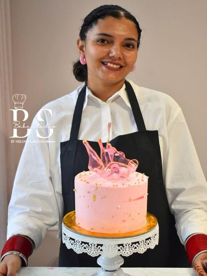 A lovely pink whipped cream cake with gold flecks and a delicate pink isomalt crown, made by a student in my class.