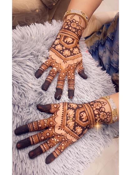 A heavy and intricate design for Teej, with multiple elephant motifs and detailed patterns covering the hands.