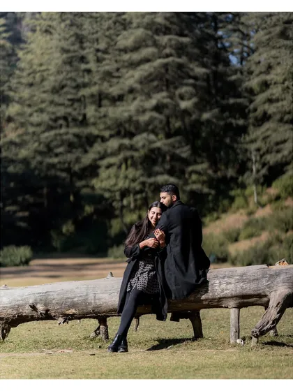 A quiet, cozy moment during a pre-wedding shoot in a forest clearing. Even in vast landscapes, I look for the intimate moments. The way they huddle together on the log tells a story of warmth and companionship.