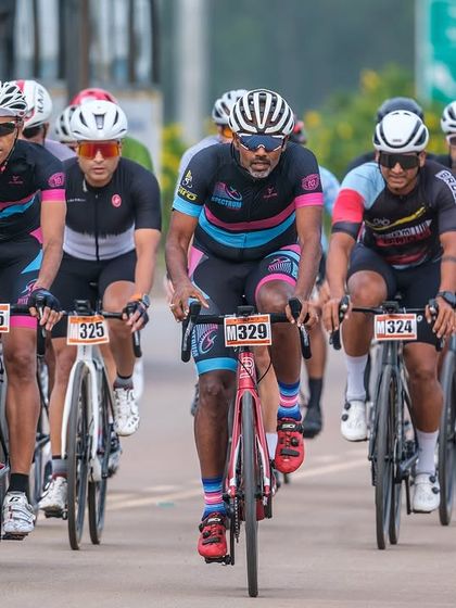 The masters peloton, a tight-knit group of experienced racers, rides with precision and control.