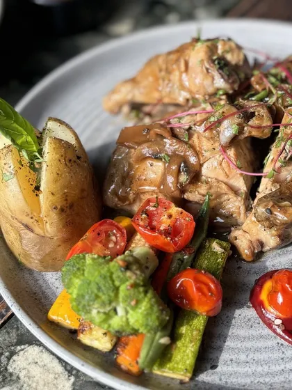 Halgali’s Roast Chicken is one of our signature main courses. It features double-grilled chicken in a creamy mushroom sauce, served with a baked potato and sautéed vegetables.