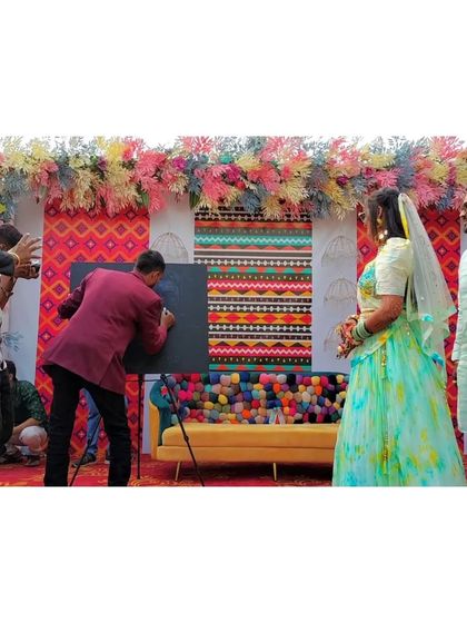 Here I am, live in action, creating the initial sketch for a glitter portrait during a wedding ceremony at Hotel Lake View, Saputara. The guests love watching the art come to life before the final reveal.