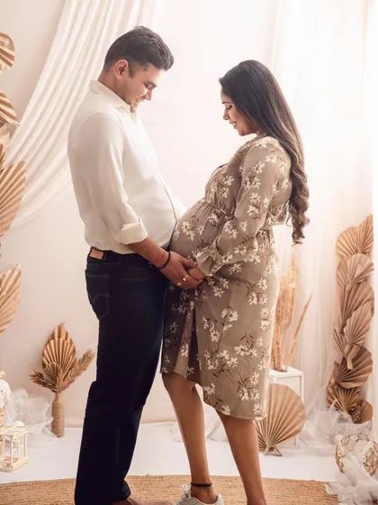A tender moment between expecting parents, framed by a soft, boho-inspired backdrop. I love capturing the anticipation and shared smiles in these couple pregnancy photos.
