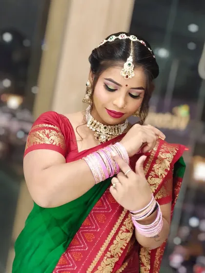 The client is adjusting her bangles, giving a lovely candid feel to this traditional look.