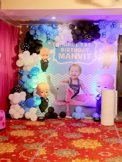 Inside Manvit's home, I set up this main decoration area for his birthday. It featured a backdrop with his photo, fun character cutouts, and a balloon garland, creating a perfect spot for cake cutting and pictures.
