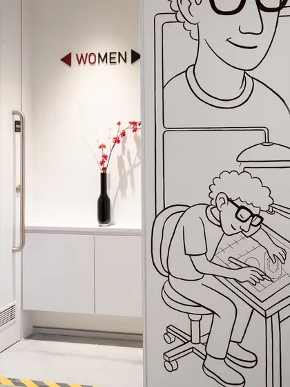 Even our restroom signage gets a creative touch. A small detail from our office that shows our playful approach to design.