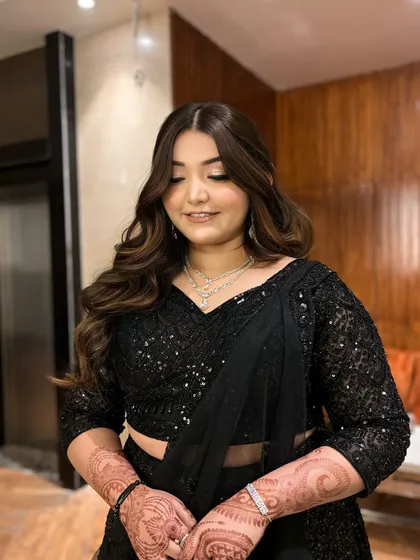 Subtle yet glam in an all-black ensemble. This look features soft smokey eyes and beautiful Hollywood waves, a classic combination for any evening event.