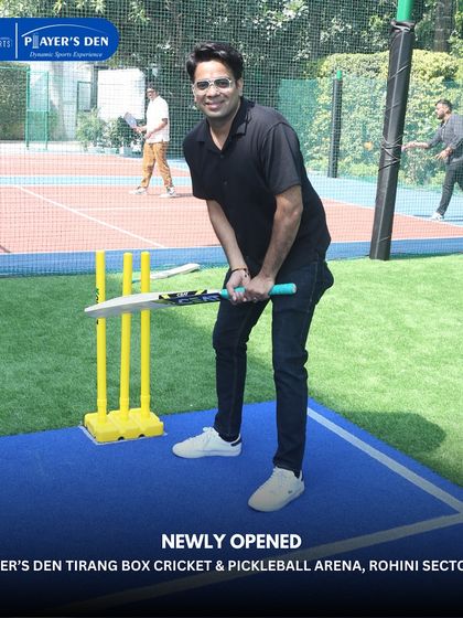 A player takes his stance, ready to face the bowler at our Rohini box cricket arena. The blue pitch provides a clear and professional surface for batting.