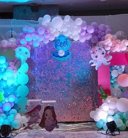 A slightly different view of the underwater baby welcoming setup, showing the iridescent quality of the sequin backdrop that mimics sparkling water.