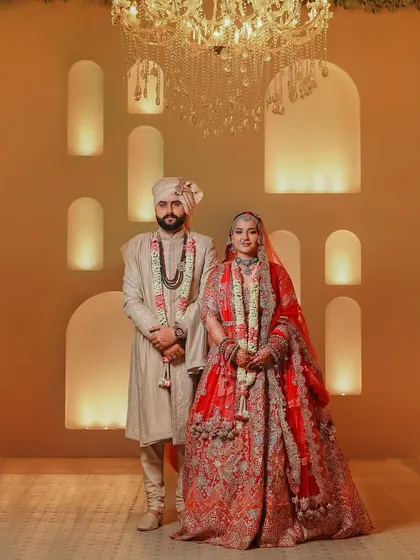 A classic wedding portrait is a timeless treasure. Here, we balanced the warmth of the ambient light and the elegance of the decor to create a regal portrait of the couple, highlighting their coordinated outfits and serene connection on their big day.