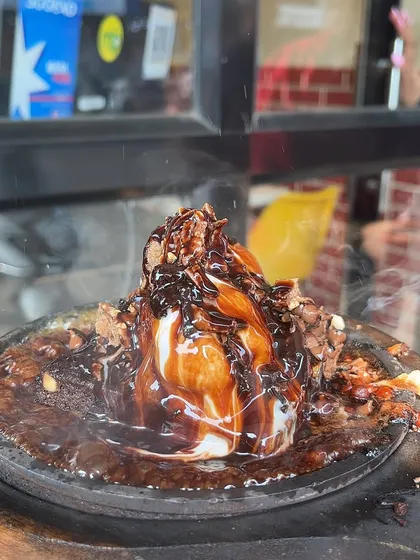 Another shot of my Sizzling Brownie, showing the steam rising from the hot plate. It's a dessert that's as dramatic as it is delicious.