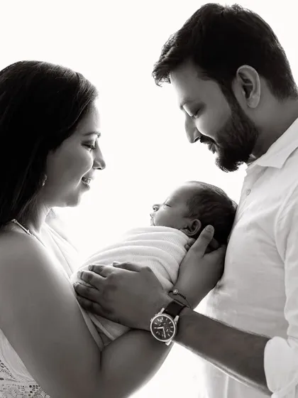 The same classic pose in black and white, which adds a timeless and artistic quality to the family portrait.