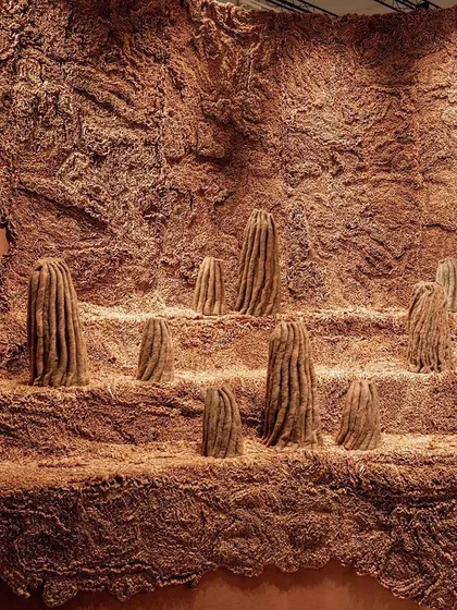 A wide view of the 'Shroom' landscape. The installation uses repeating organic forms and rich textures to represent the quiet strength and resilience of the fungal world.