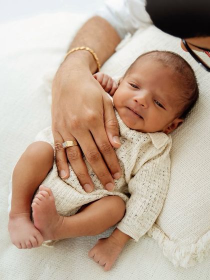 A father's comforting hand on his baby's chest. This simple gesture conveys so much love and security.
