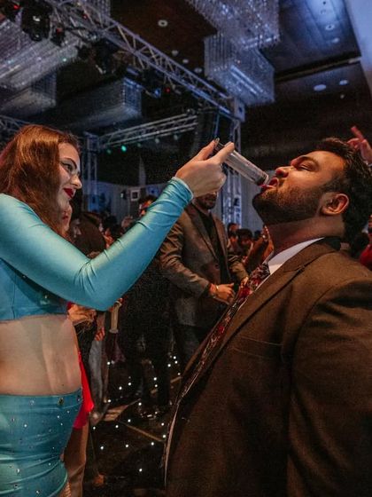 "Trust me, you can dance." One of our international hostesses serves a shot to a guest, encouraging everyone to let loose and enjoy the party.