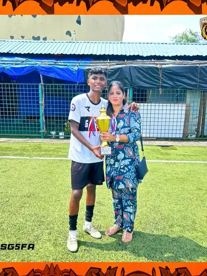 A player and his mother with the trophy. We recognize the immense role parents play in the success of our young athletes.