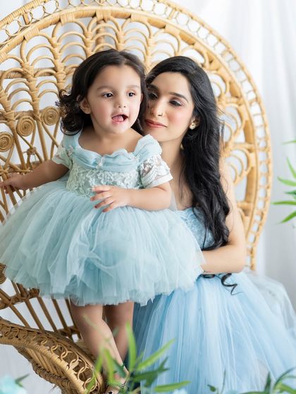 A close-up of the mother and daughter, capturing a candid and sweet expression from the little one.