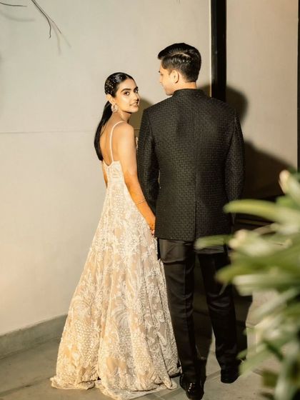 A modern and chic portrait of the couple, with the bride looking over her shoulder, showcasing their effortless style.