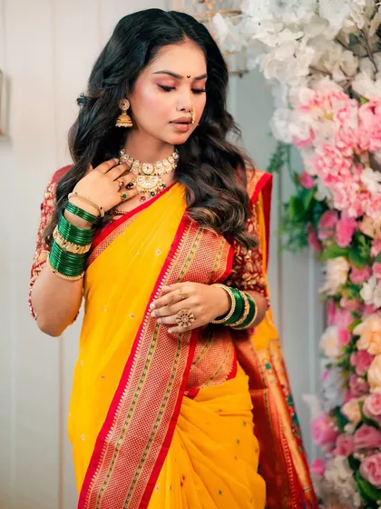 A closer look at the soft eye makeup and traditional jewelry complementing the vibrant yellow saree.